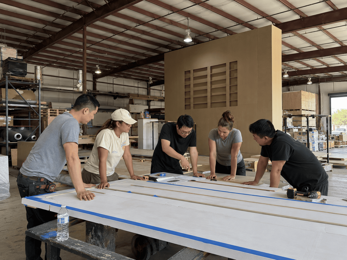 Workshop team reviewing booth fabrication details